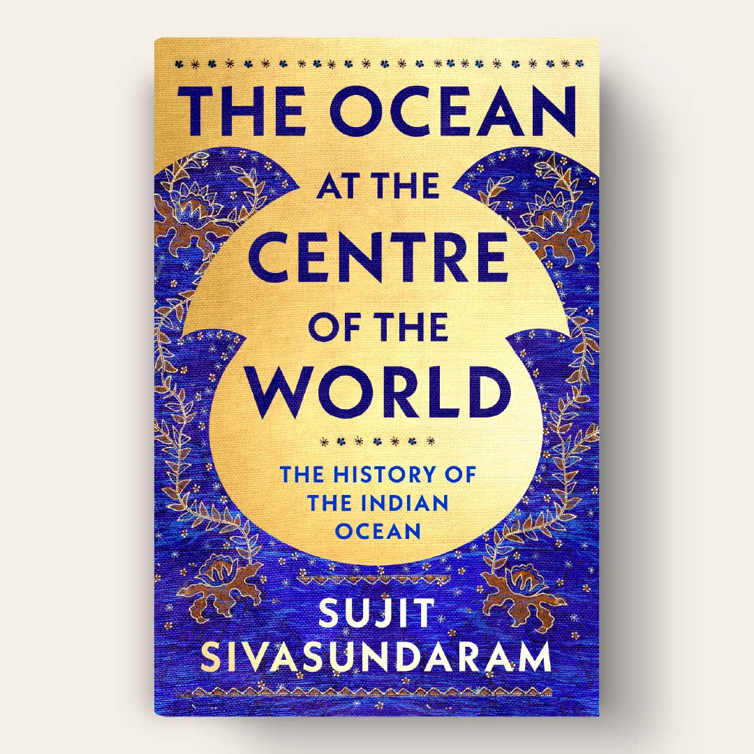 The cover features Indonesian tapestry decorations and wave like graphic shapes above a gold foil background.