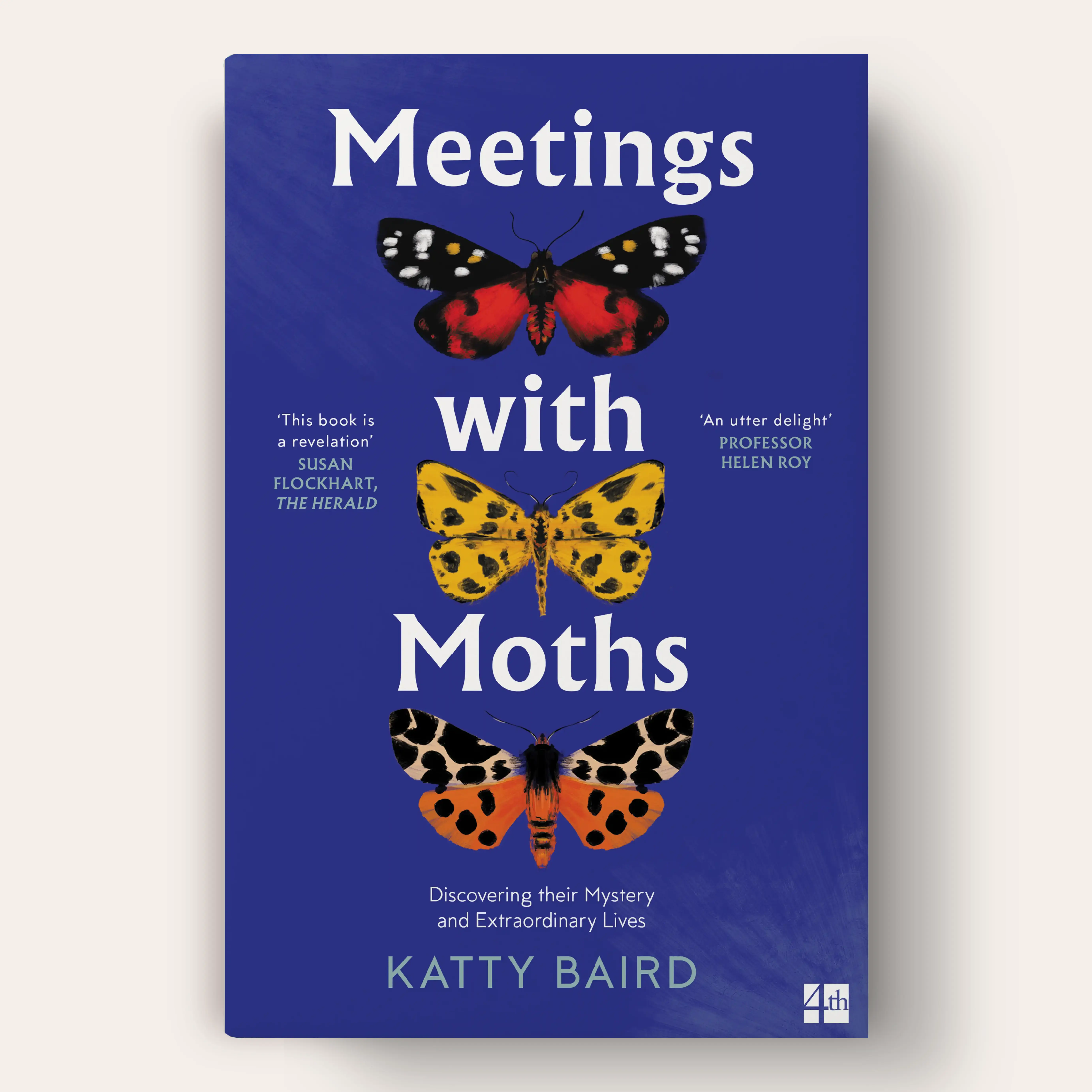 A blue book cover featuring three moths in vibrant colors: one in red and black, another in yellow with black spots, and a third in orange and black. The title, 'Meetings with Moths,' is written in large white text, with the subtitle, 'Discovering their Mystery and Extraordinary Lives,' appearing below.